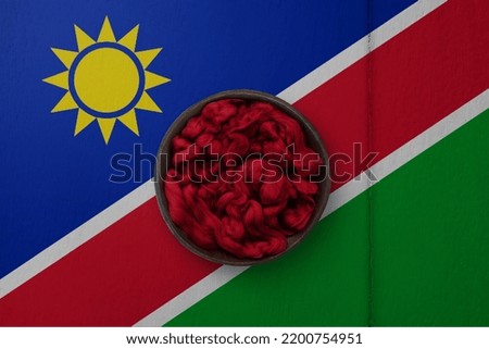 Wooden basket on background in colors of national flag. Photography and marketing digital backdrop. Namibia