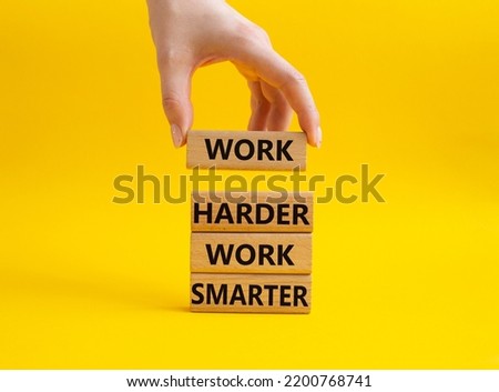 Work harder Work smarter symbol. Wooden blocks with words Work harder Work smarter. Beautiful yellow background. Businessman hand. Business concept. Copy space.
