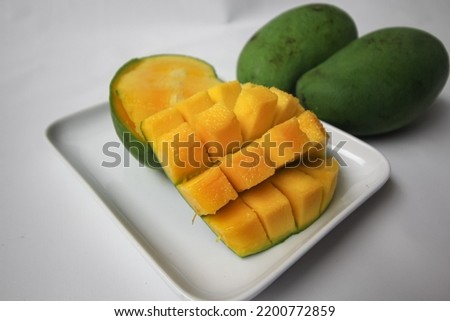 Set of mango cubes and mango slices isolated on a white background.
