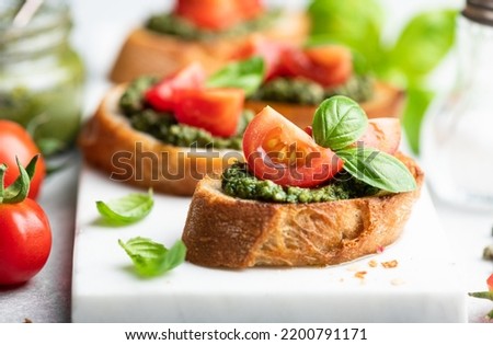 Pesto bruschetta with cherry tomatoes and basil, selective focus Royalty-Free Stock Photo #2200791171