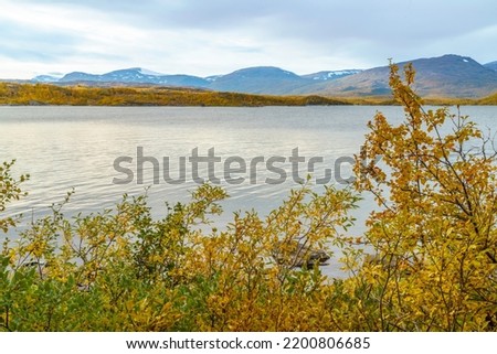 Autumn landscape in Kiruna county, mountains with snow and Torneträsk lake, Kiruna county, Swedish Lapland, Sweden