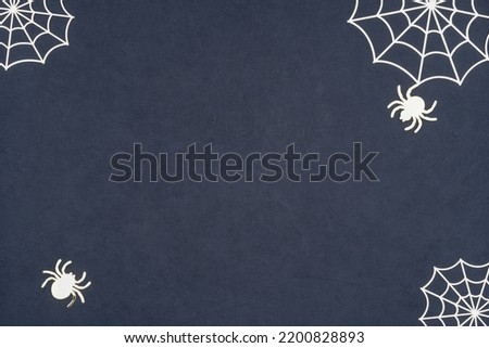 Spider and cobweb background. The scary Halloween decoration with golden shiny spider and cobweb on a dark textured backdrop. Halloween theme with copy space. Royalty-Free Stock Photo #2200828893