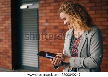 Beautiful young college student having a break outdoors while chatting by mobile phone. Copy space. People urban lifestyle concept. Business portrait.