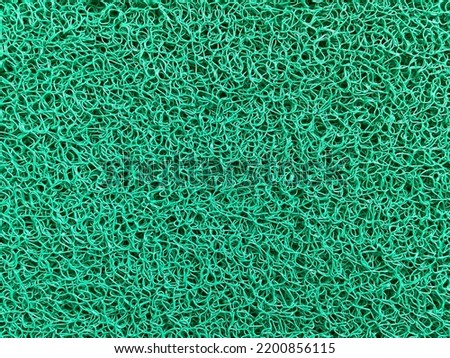 
Green background on a mat with complex and intricate mesh pores.