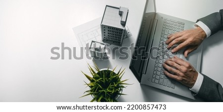 real estate business and development, property management. businessman using laptop and working on housing project in office. banner with copy space Royalty-Free Stock Photo #2200857473