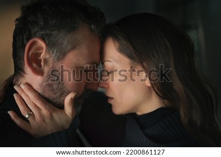 Close-up of woman crying when hugging her husband. Royalty-Free Stock Photo #2200861127