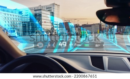Futuristic Self-Driving Concept Car Moving Through City, Head-up Display HUD Showing Infographics: Speed, Distance, Navigation, Fuel. Road Scanning. Driver Seat Point of View POV or FPV.