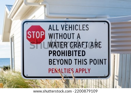Road sign on the sea beach  STOP All vehicles without a water craft are prohibited beyond this point Penalties apply Australia