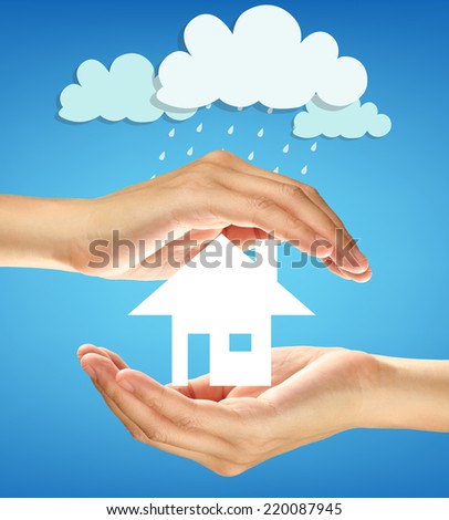 business concept. Hands protect a small house from raining