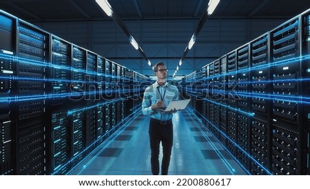Futuristic 3D Concept: Big Data Center Chief Technology Officer Using Laptop Standing In Warehouse, Information Digitalization Lines Streaming Through Servers. SAAS, Cloud Computing, Web Service Royalty-Free Stock Photo #2200880617