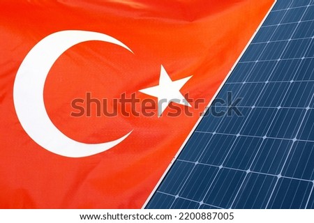Solar panels against flag Turkey background. Solar battery generates a pure electricity. Concept of sustainable resources and renewable energy in Turkey