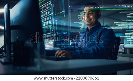 Futuristic Office with Hologram Screens: Professional Indian Programmer Working on Computer with Holographic Projection Showing Big Data, Charts. Asian Specialist Creating Innovative Software