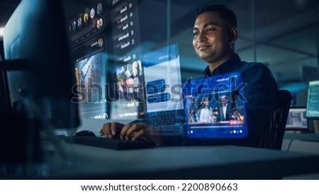 Futuristic Computer User Hologram Screens Concept: Indian Man Login, Use PC with Holographic Projection, Displays Show Websites, Video Streaming Services, Social Media, e-Commerce, e-Learning Content Royalty-Free Stock Photo #2200890663