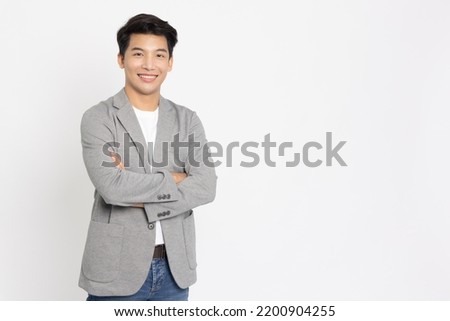 Young Asian businessman smilling with arms crossed isolated on white background Royalty-Free Stock Photo #2200904255
