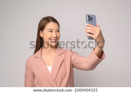 A Young asian woman using smartphone over white background, technology concept. 		
