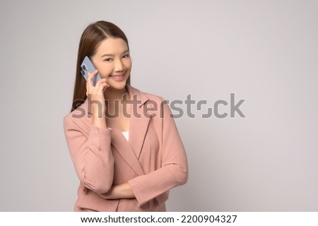 A Young asian woman using smartphone over white background, technology concept. 		