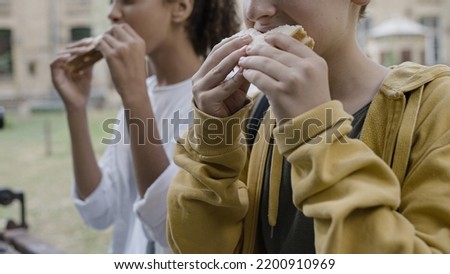 School children eating sandwiches, having meal after classes, kids nutrition Royalty-Free Stock Photo #2200910969