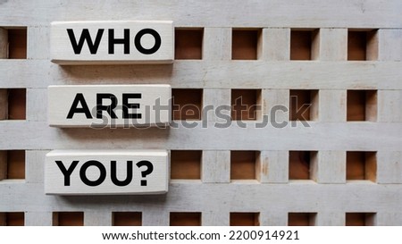Who are you, question written on wooden blocks and vintage background