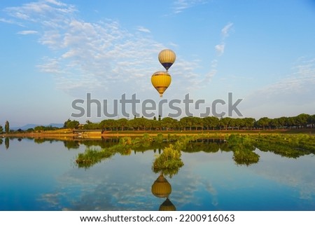 hot-air balloons reflected on the lake