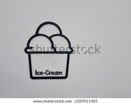 Black ice cream text and logo isolated on white gray wall background.