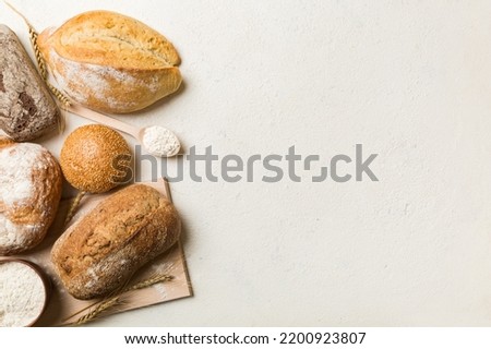 Homemade natural breads. Different kinds of fresh bread as background, top view with copy space. Royalty-Free Stock Photo #2200923807