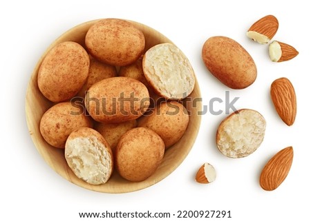 Marzipan balls or potatoes with almond in wooden bowl isolated on white background full depth of field. Top view. Flat lay