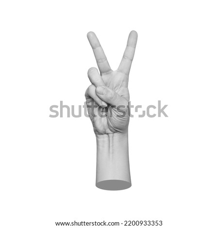 Female hand showing a peace gesture isolated on a white background. 3d trendy collage in magazine style. Contemporary art. Modern design. Victory hand sign Royalty-Free Stock Photo #2200933353