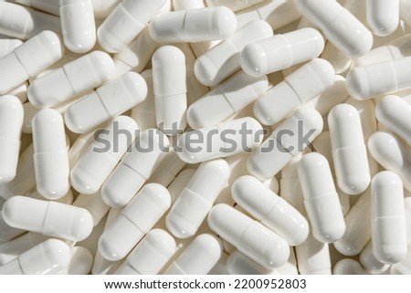 Capsules with medicine, vitamins or sports supplement close-up. Royalty-Free Stock Photo #2200952803