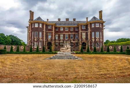 Sculpture in front of an old estate. Old mansion. Old mansion exterior. Old mansion view Royalty-Free Stock Photo #2200958657