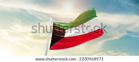 Kuwait national flag waving in beautiful sky. Royalty-Free Stock Photo #2200968971