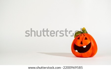 Funny pumpkin figure on a light background.