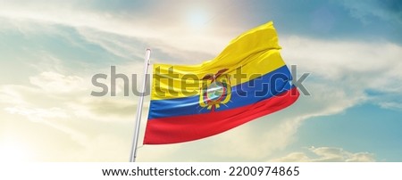 Ecuador national flag waving in beautiful sky. Royalty-Free Stock Photo #2200974865