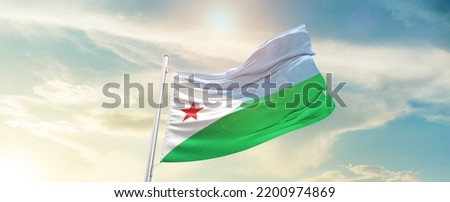 Djibouti national flag waving in beautiful sky.