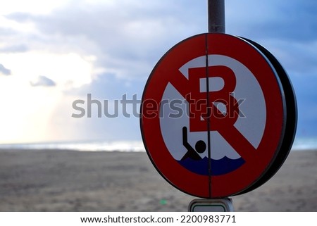 No swim sign in the North Sea beach in Ostend, Belgium - spring season