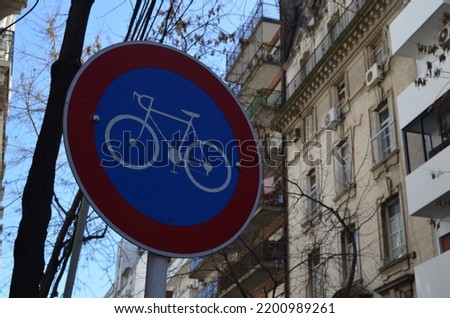 Blue and red bike path sign