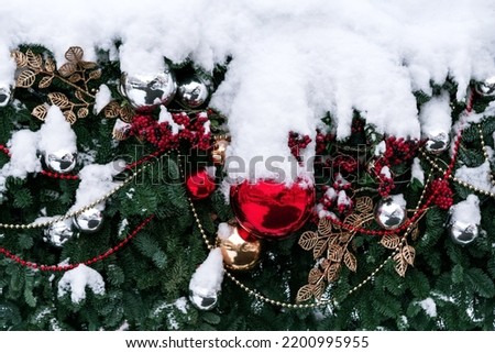 Beautiful snowy fir trees decorations and lights of traditional Christmas fair. Holidays concept. Winter holiday season background.
