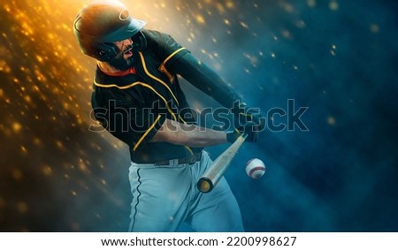 Baseball player with bat taking a swing on grand arena. Ballplayer on dark background in action.  Sports betting. Bets in the mobile application.
