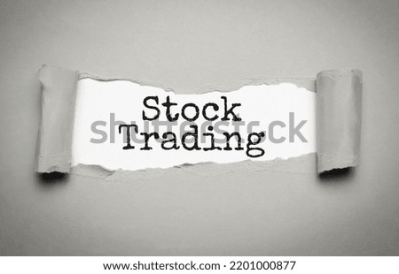 stock trading on torn paper and grey background