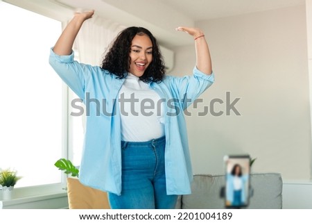Modern Blogging. Joyful Black Blogger Lady Dancing Filming Video On Cellphone For Social Media Blog, Having Fun Posing At Home. Selective Focus On Cheerful Plus Size Woman