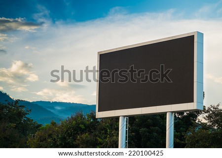 Black billboard with space for your advertisement against blue sky