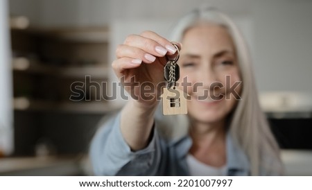 Old happy woman homeowner buyer female mature lady seller realtor tenant adult caucasian granny show bunch keys of accommodation house rental flat win new property apartment buy loan housing dwelling Royalty-Free Stock Photo #2201007997