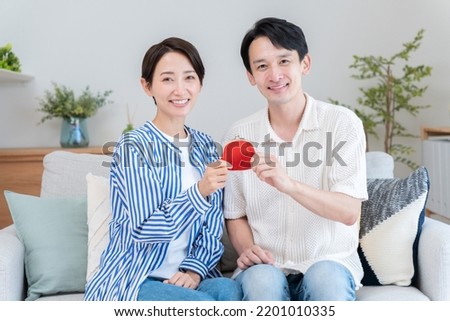 An Asian couple with wallet