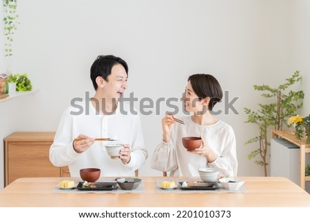 An Asian couple eating a meal Royalty-Free Stock Photo #2201010373