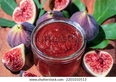 Sweet figs jam and raw figs closeup. Figs whole and cut into halves. Organic gardening. High quality photo