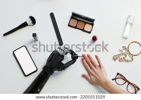 High angle view of girl with disability painting her nails with nail polish Royalty-Free Stock Photo #2201011029