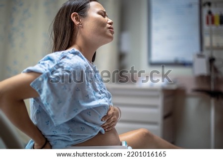A woman in labor having contractions in the hospital delivery room. Childbirth and pregnancy. Royalty-Free Stock Photo #2201016165