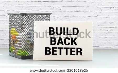 Build back better written in white chalk on a black chalkboard isolated on white. Royalty-Free Stock Photo #2201019625