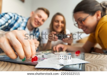 Friends play board game.Focus on dice. 