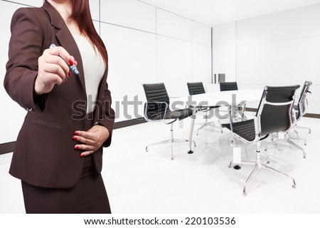 business woman writing on virtual screen at conference room in modern office interior 