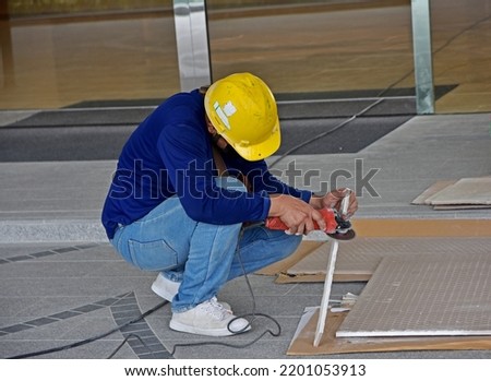 A worker is cutting things with a chainsaw.